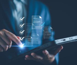 Hombre con una tablet gestionando archivos que aparecen de manera holográfica